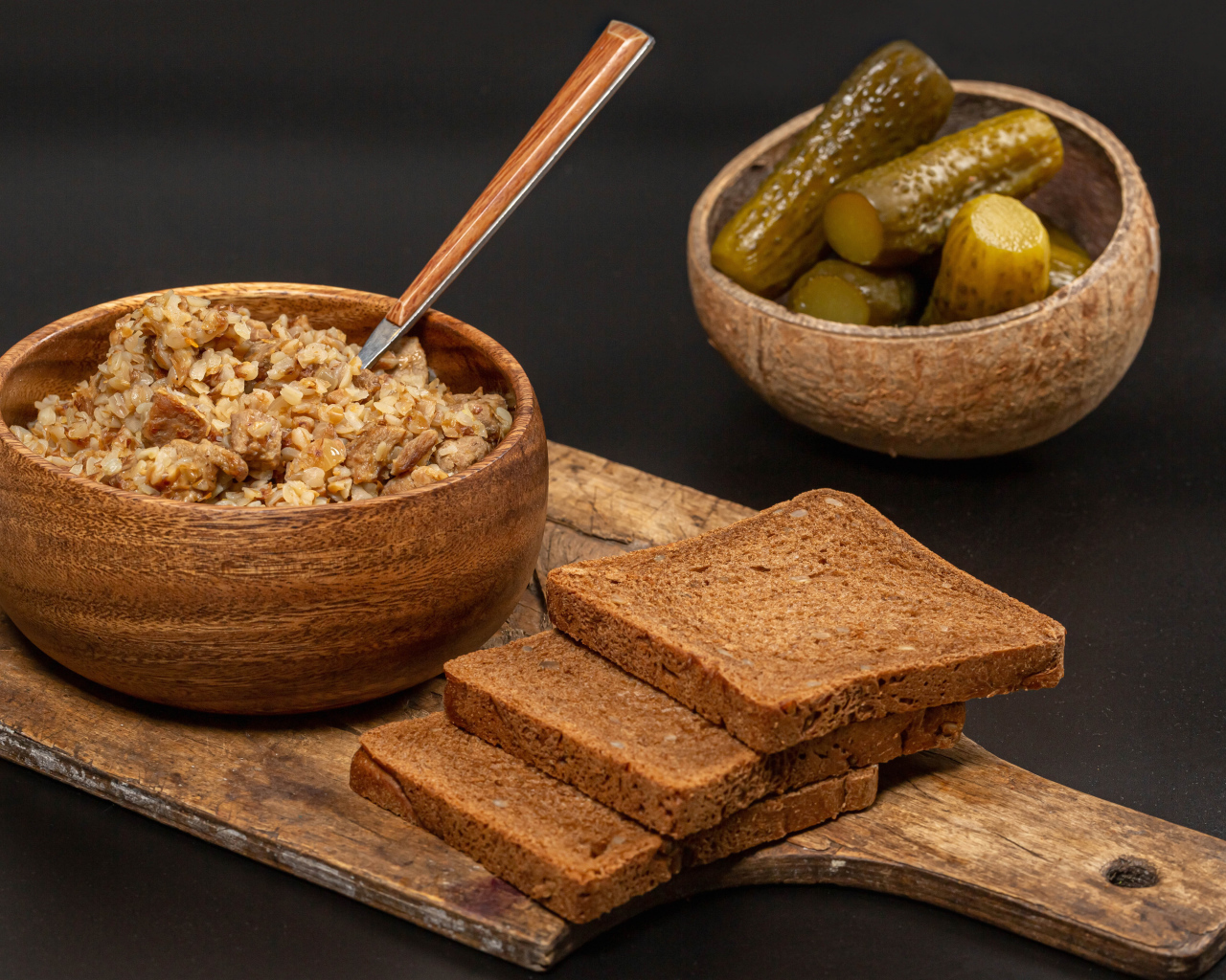 Гречка на столе с хлебом и огурцами