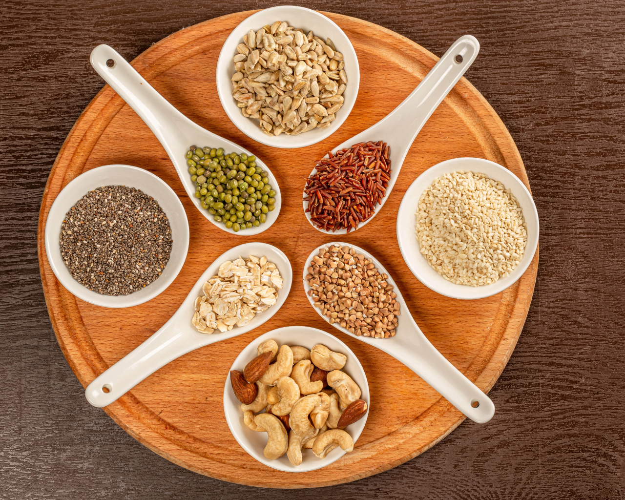 Зерна и орехи на доске на столе 