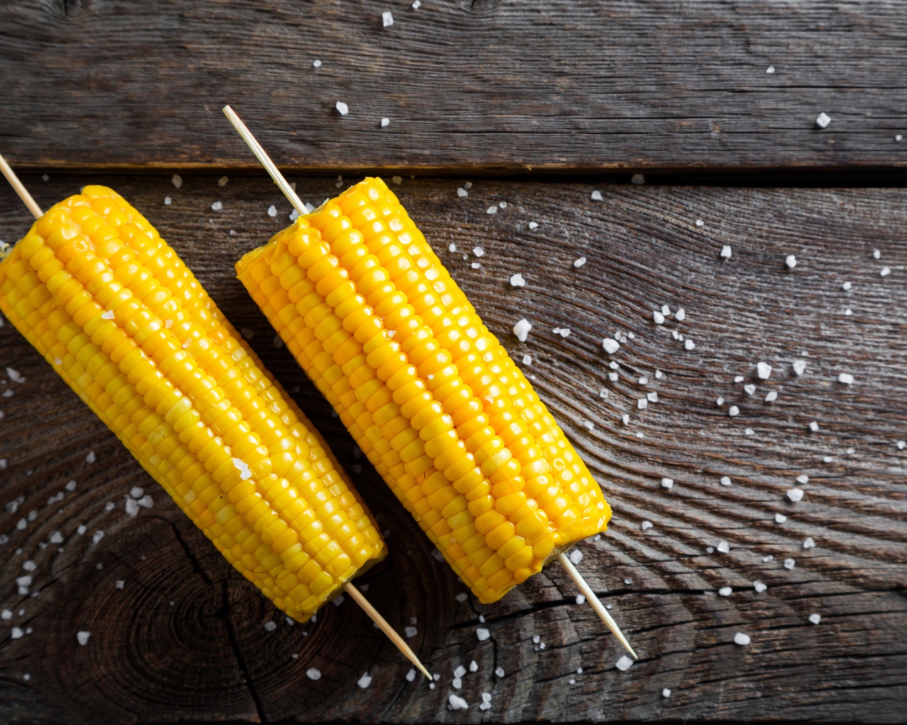 Два початка вареной кукурузы на столе 