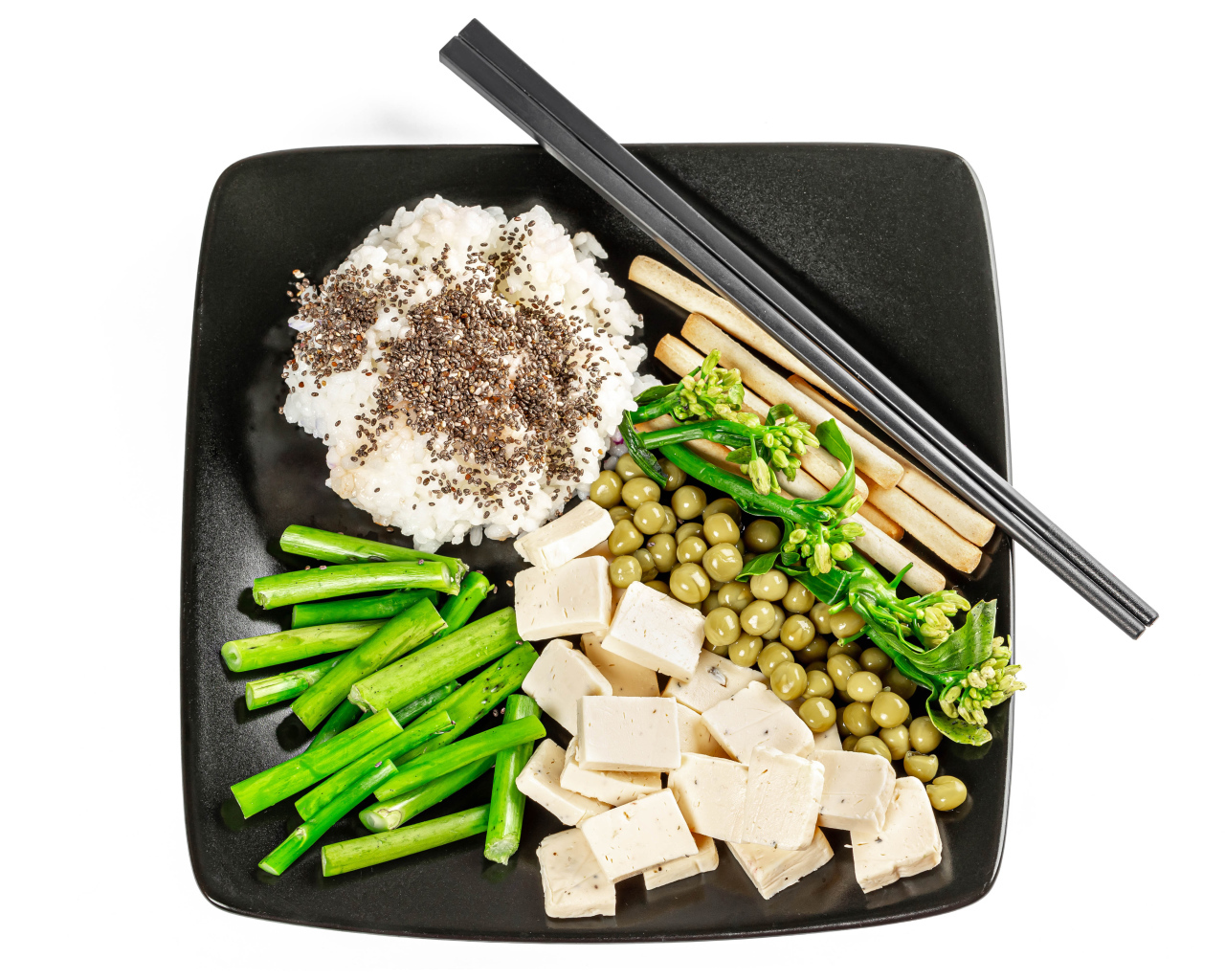 Овощи, сыр и рис на тарелке с палочками