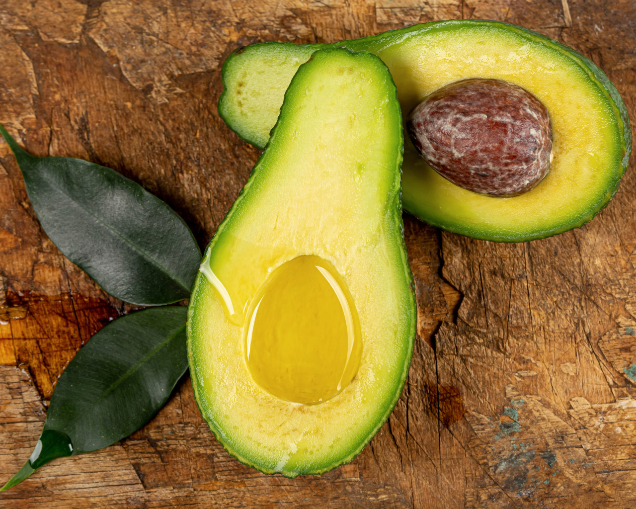 Зеленое авокадо на деревянном столе
