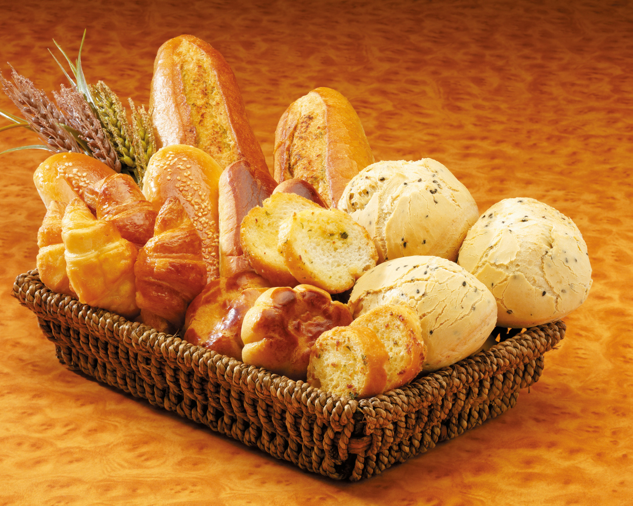 Вкусная свежая выпечка в корзине на столе 