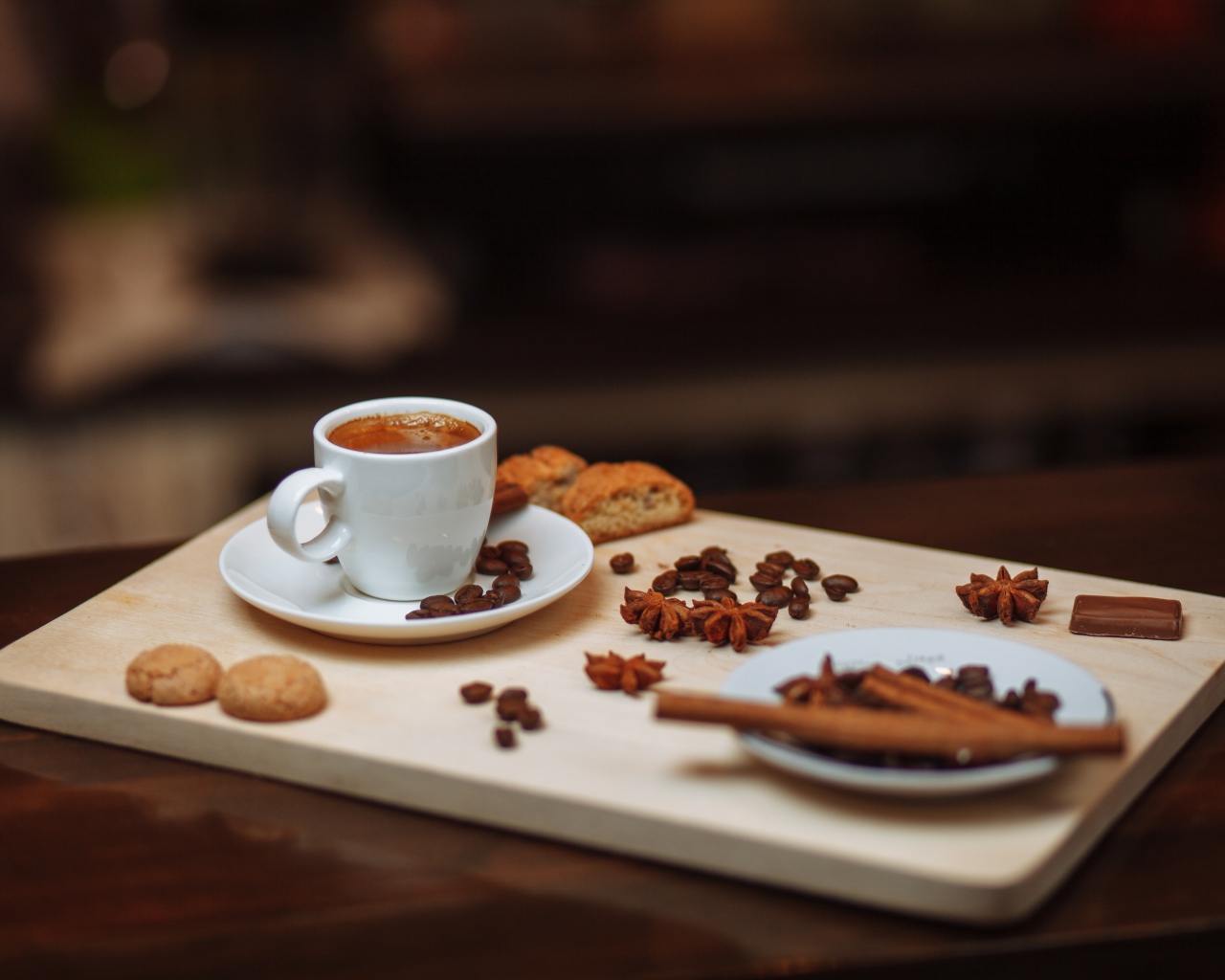 Маленькая чашка кофе на столе с корицей, бадьяном и печеньем 