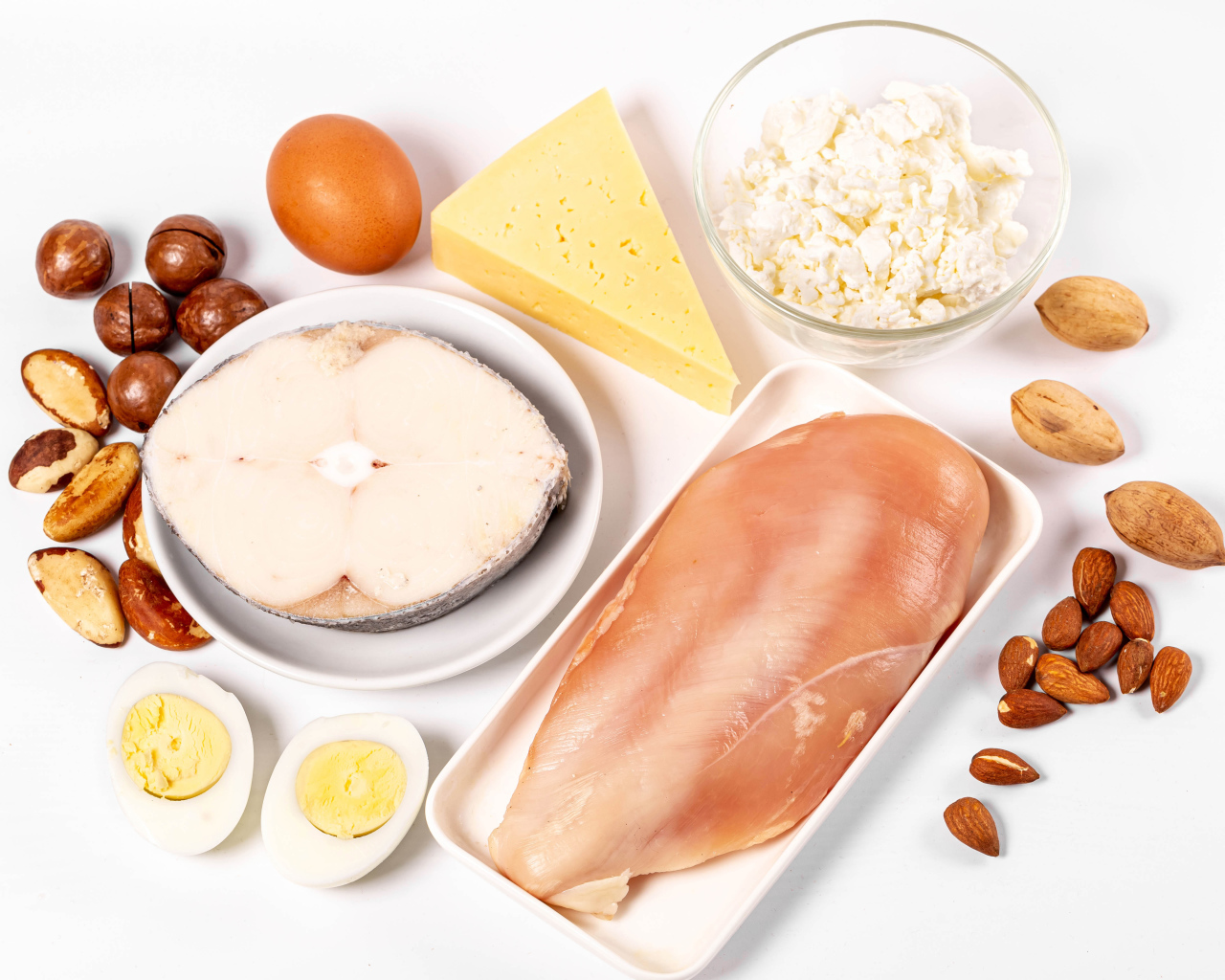 Fresh chicken, fish, nuts, cottage cheese and eggs on the table