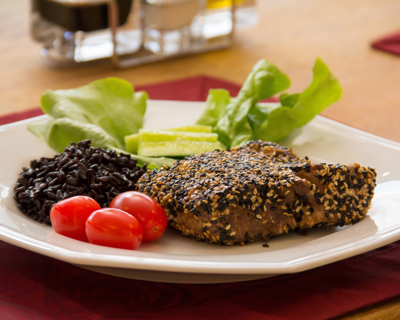 Кусок мяса на тарелке с рисом и овощами 