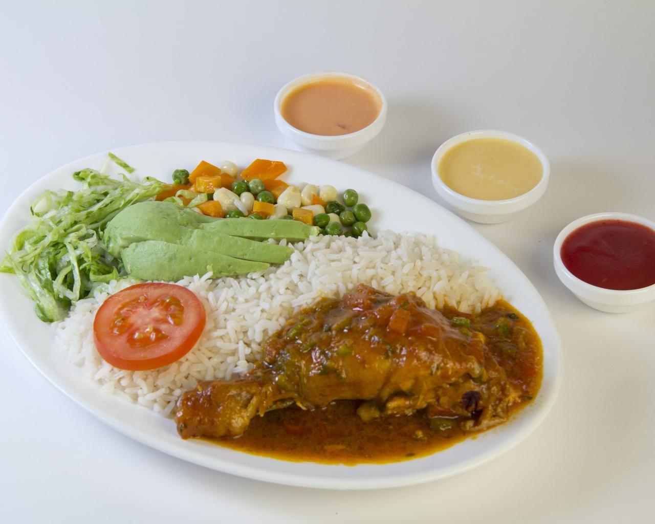 Rice with chicken and vegetables on the table with sauce