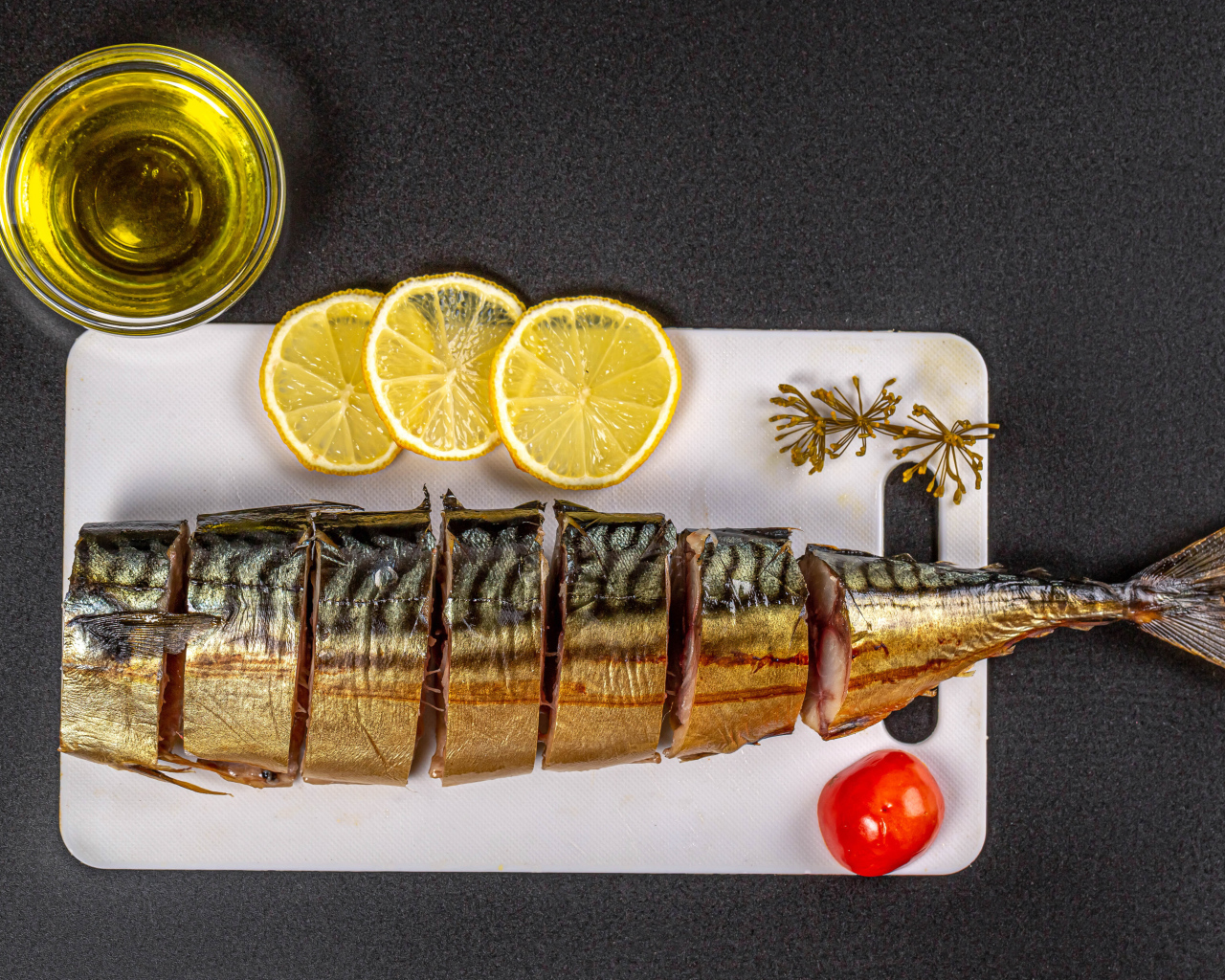 Appetizing mackerel on a board with lemon and butter