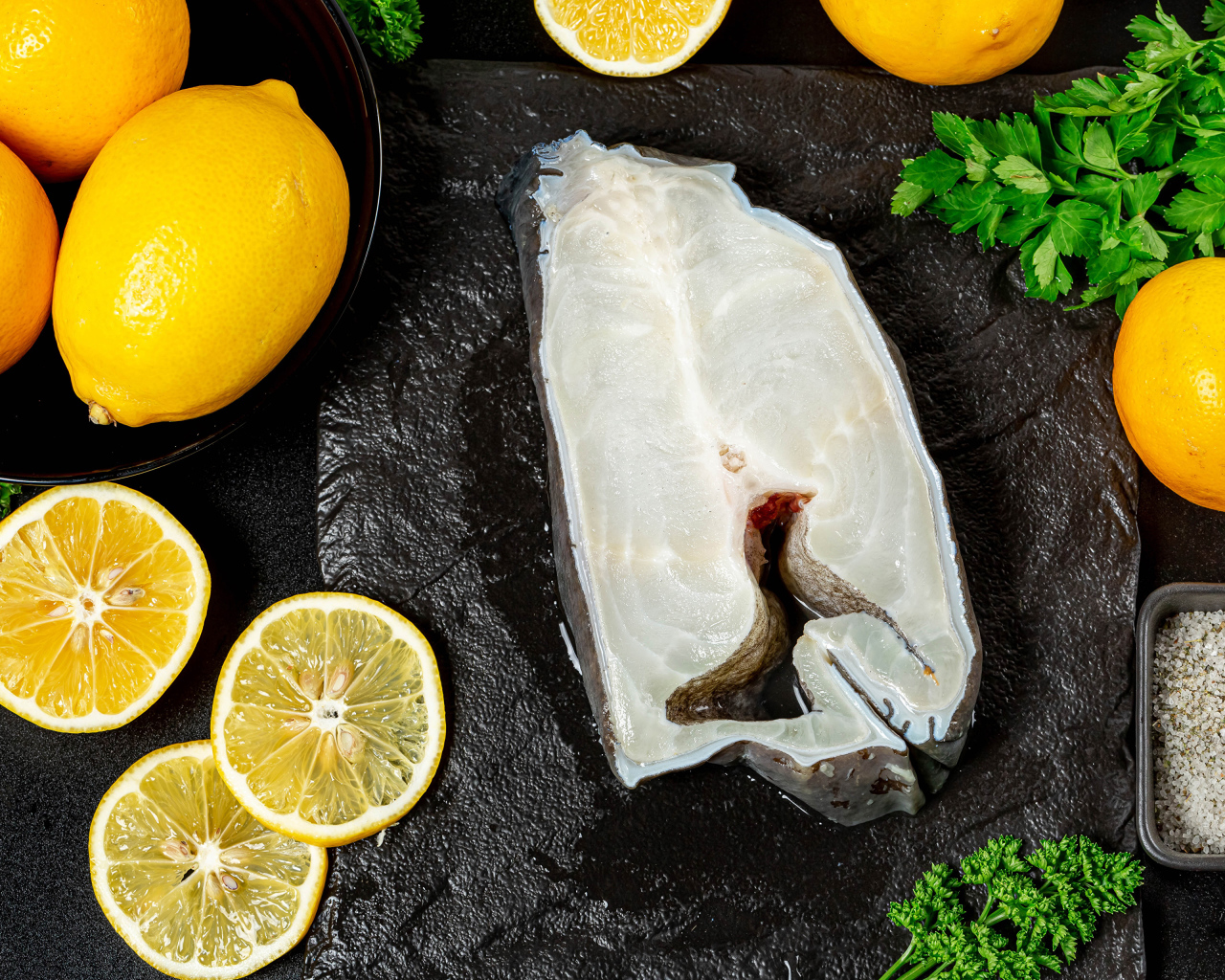 Piece of fish with lemon and parsley