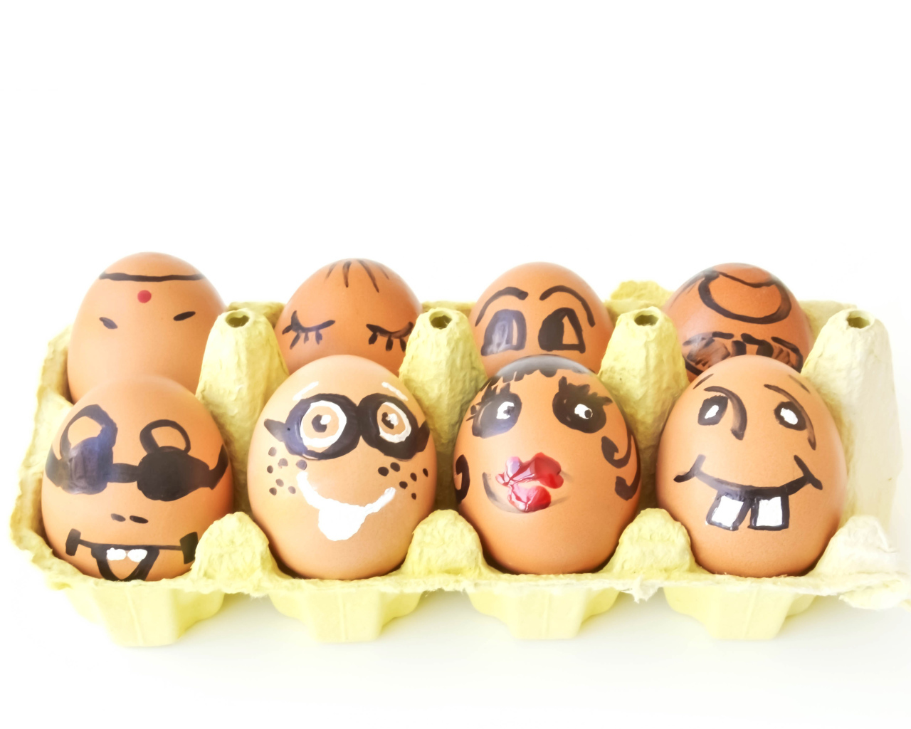 A dozen eggs with drawings on a white background