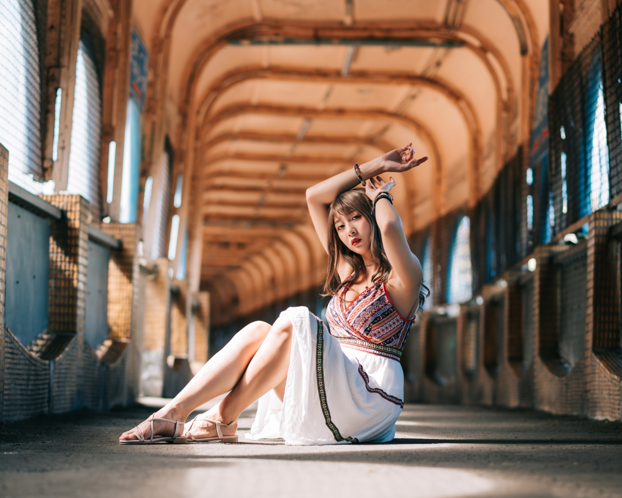 Девушка азиатка сидит в переходе 