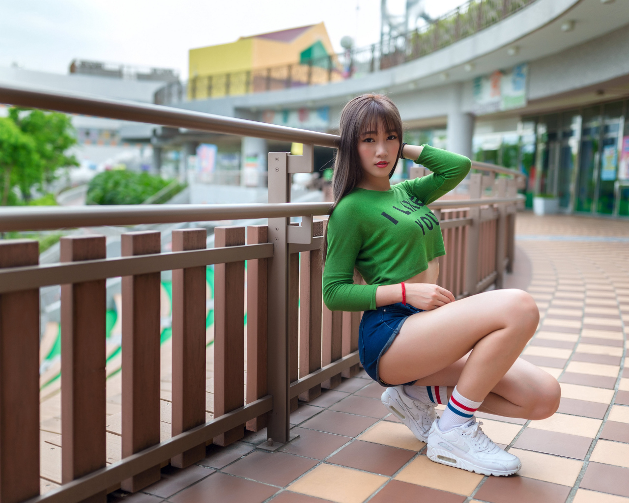 Красивая молодая азиатка в белых кроссовках 