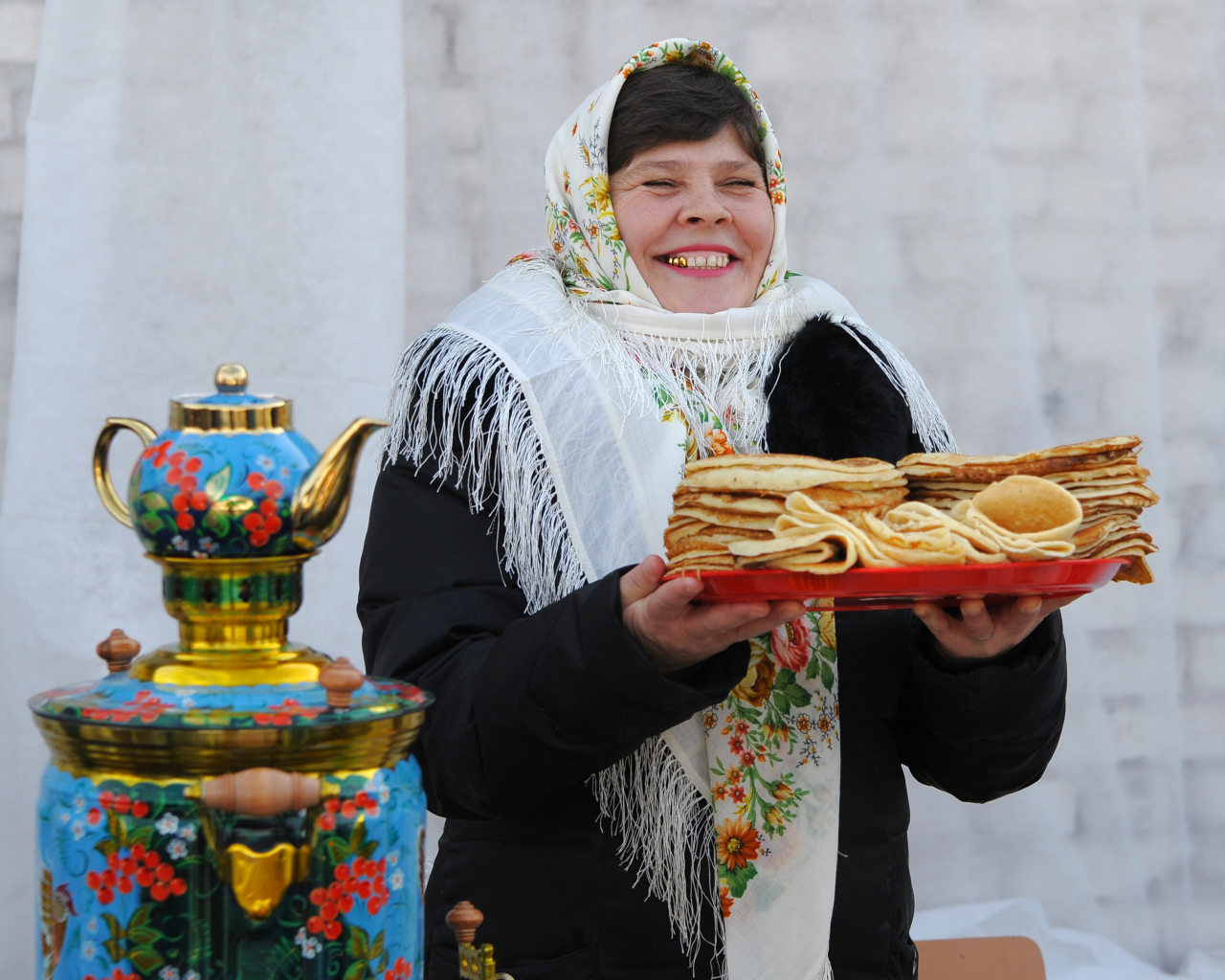 Женщина с блинами и самоваром на Масленицу