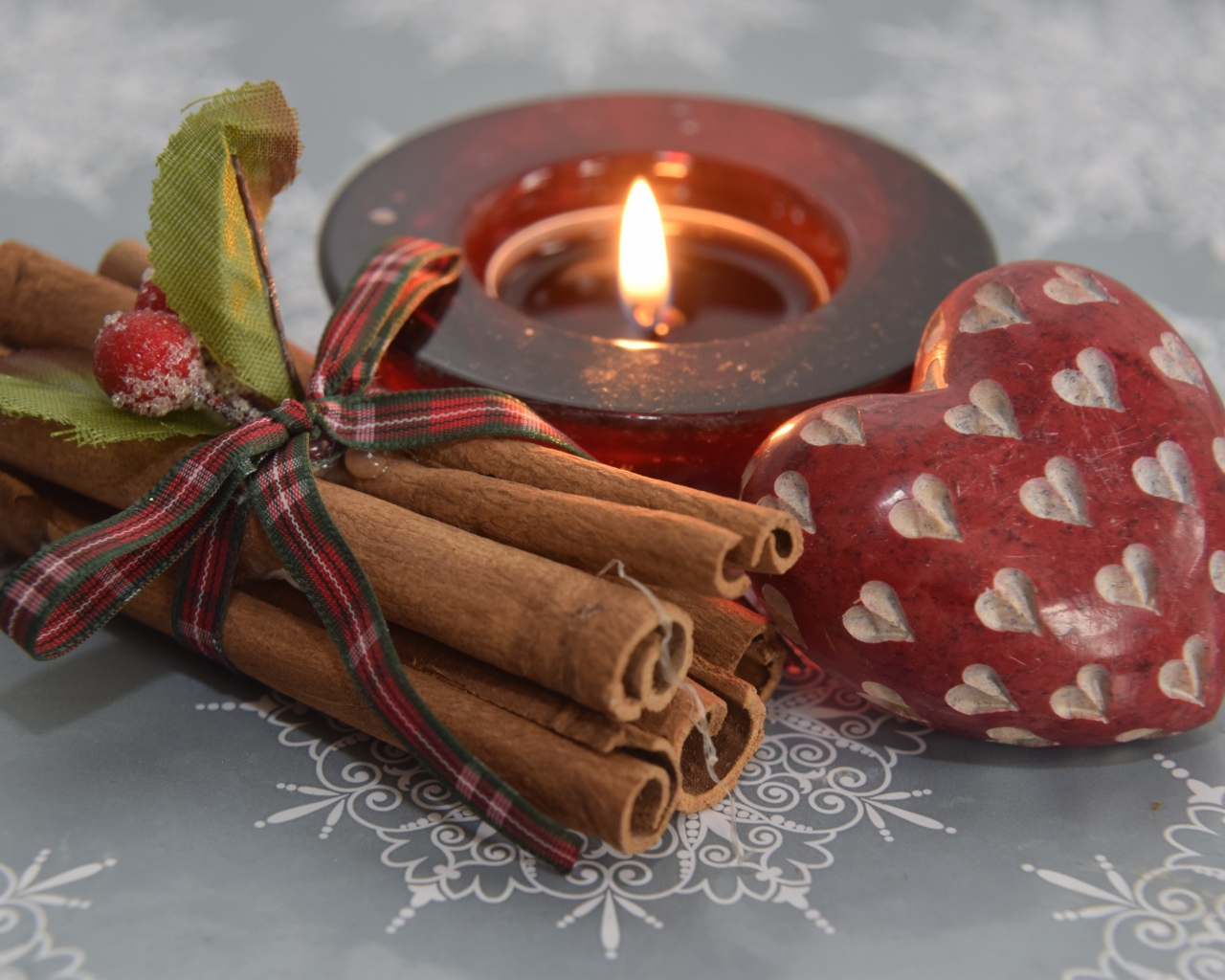 Cinnamon, candle and heart on the table