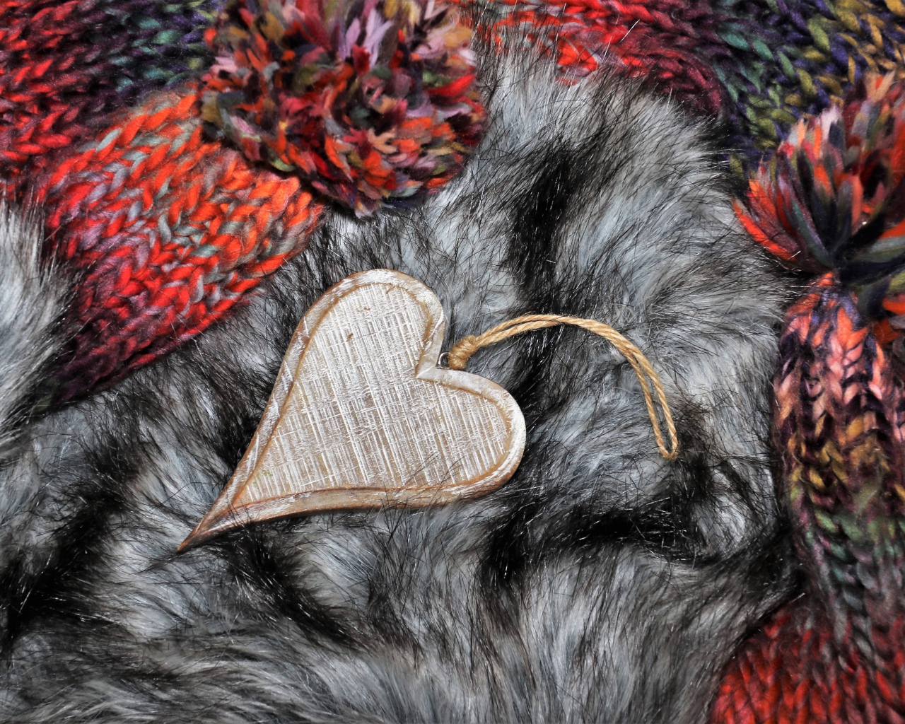 Wooden heart lies on a fur hat