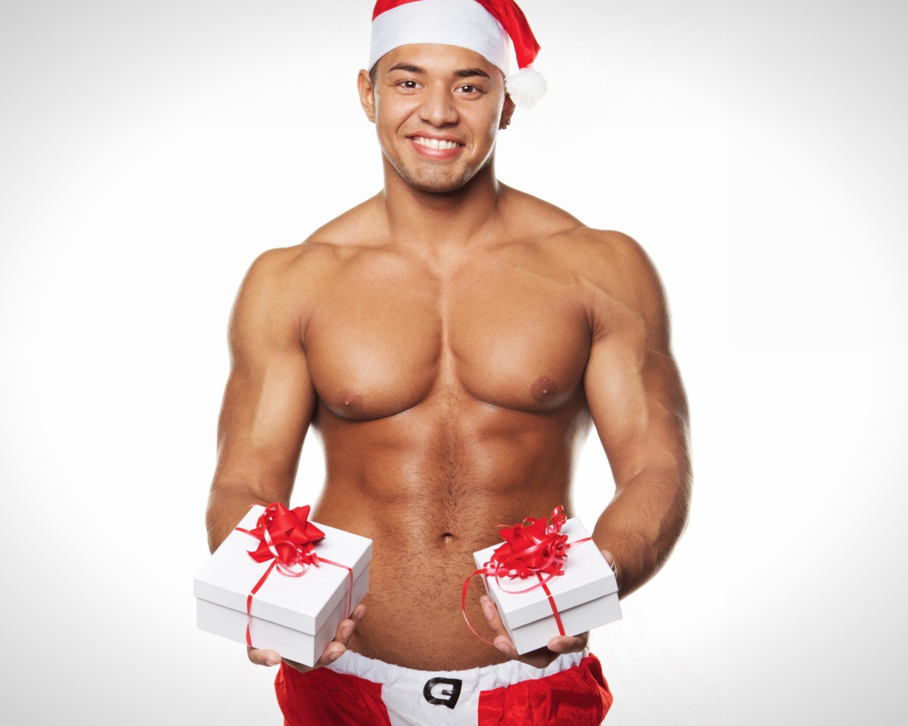 Накаченный мужчина в новогоднем костюме с подарками 