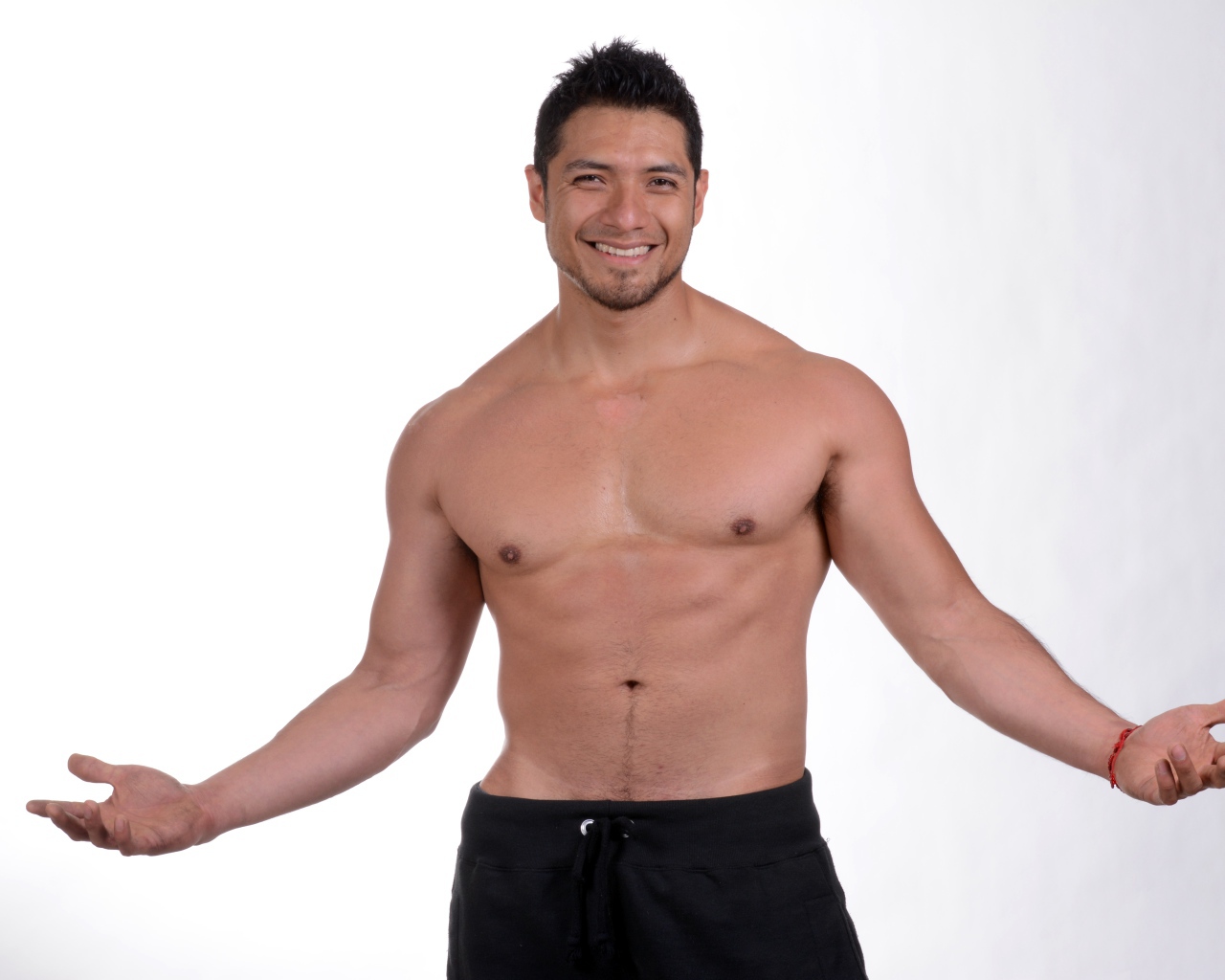 Улыбающийся накаченный мужчина на сером фоне