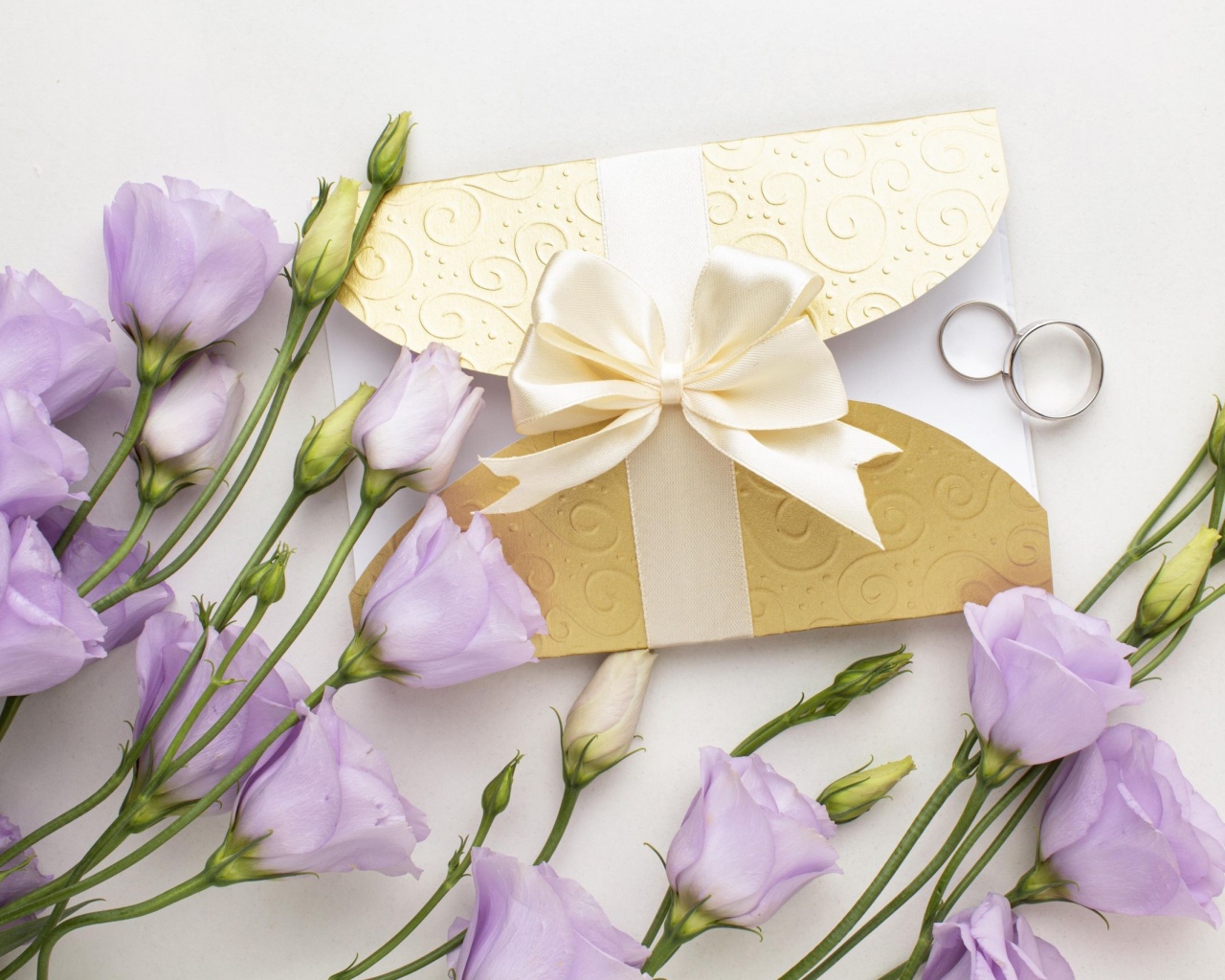 Фиолетовые цветы эустома с приглашением и обручальными кольцами