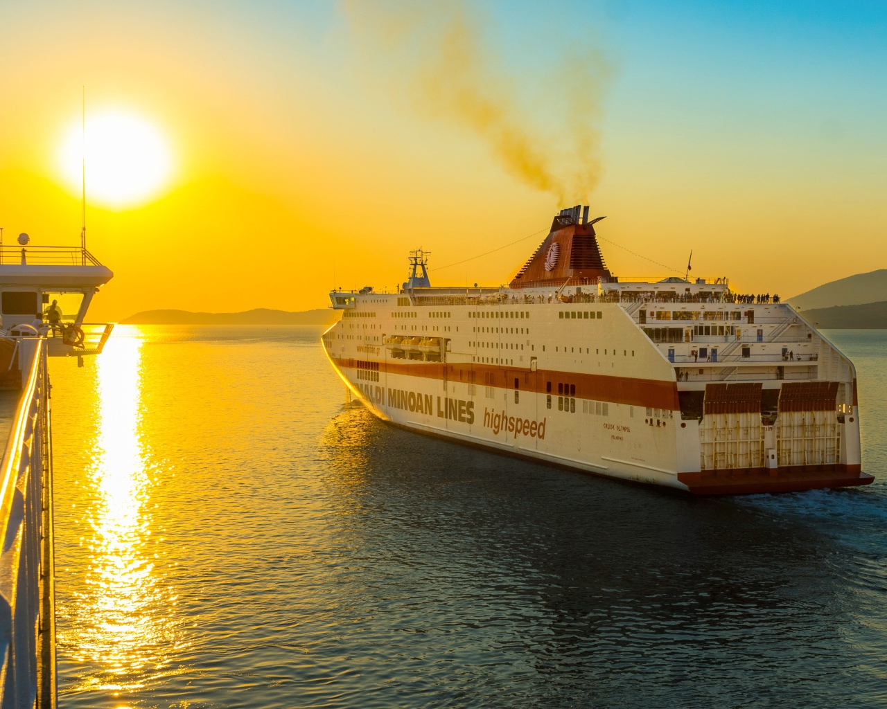 Large cruise ship sailing into the sunset