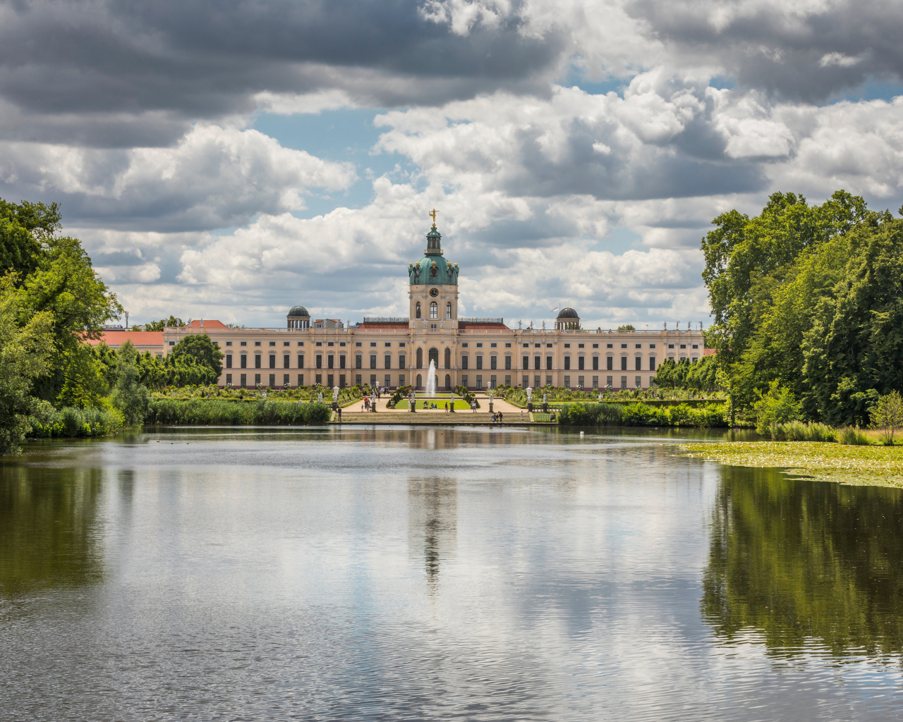 Красивый вид на замок Шарлоттенбург у озера под белыми облаками