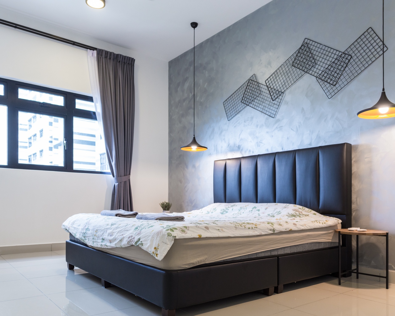 Пустая спальная комната с большой кроватью у окна 