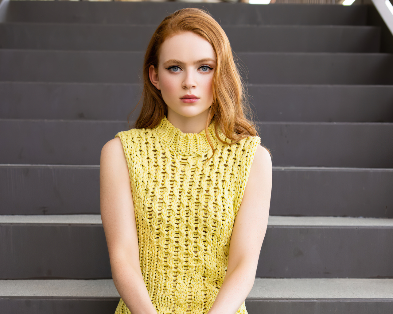 Red-haired girl actress Sadie Sink on the steps