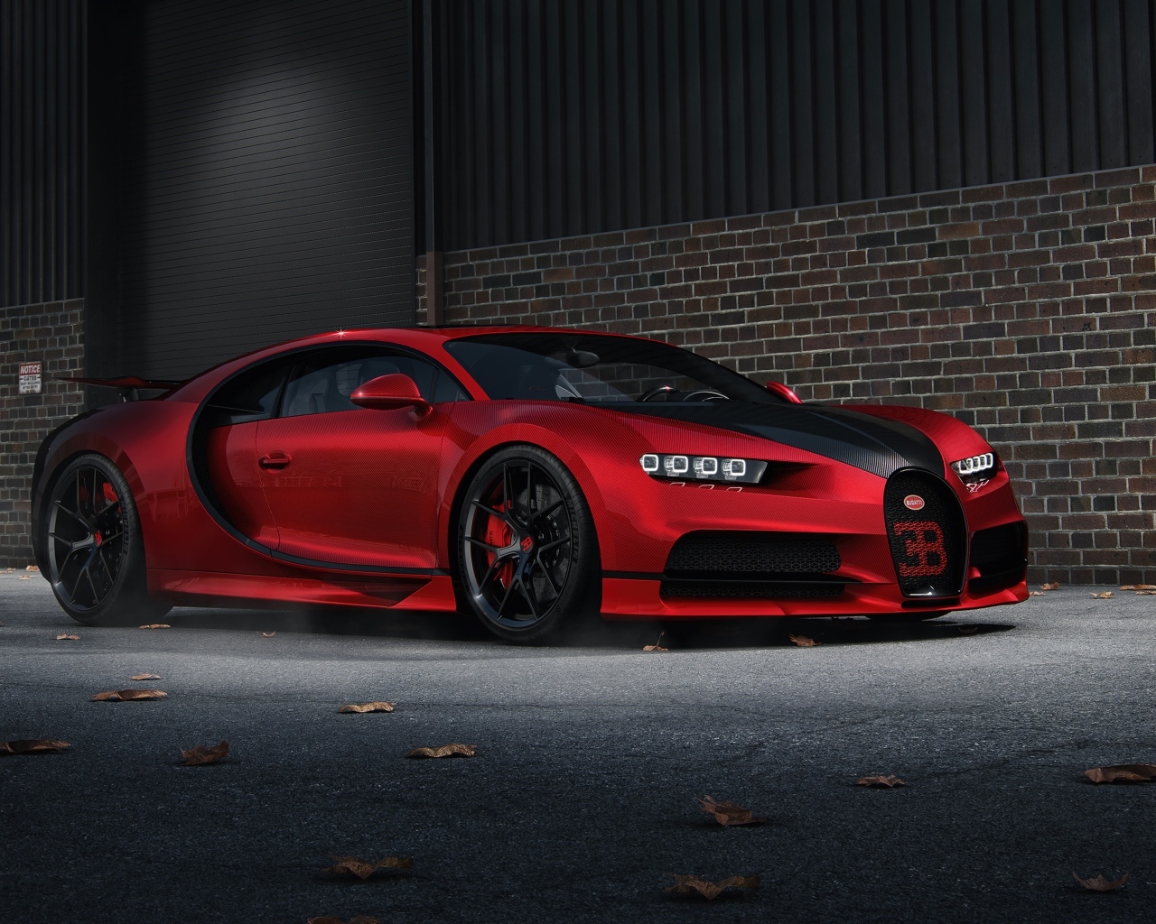 Красный автомобиль Bugatti Chiron CGI у кирпичной стены