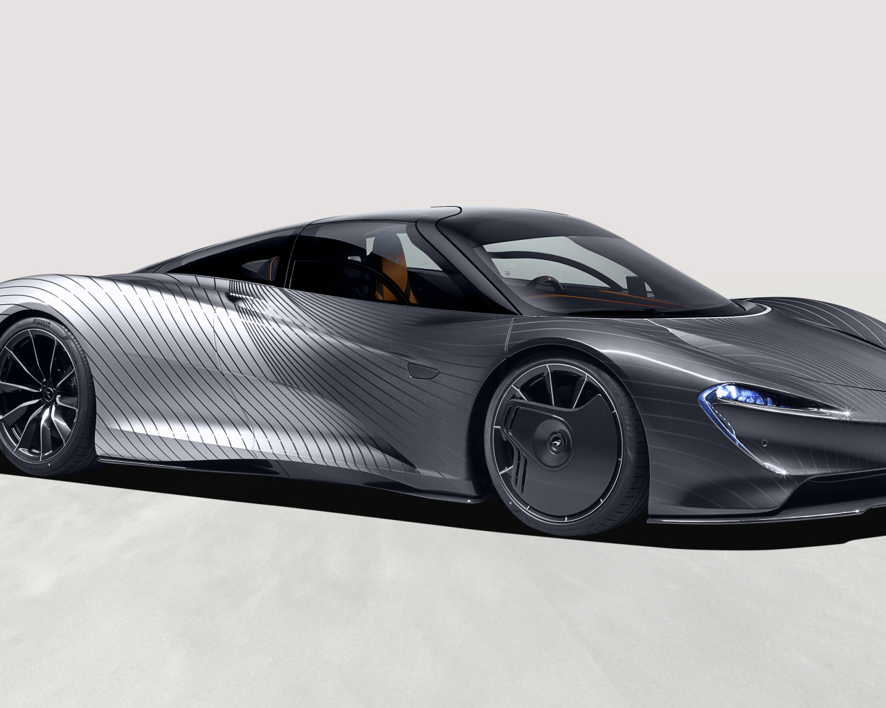 Серебристый McLaren MSO Speedtail Albert Hommage на сером фоне 