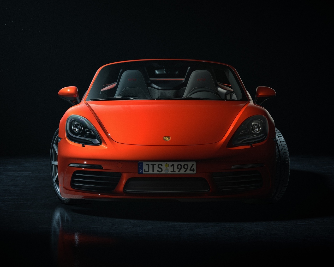 Красный автомобиль Porsche 911 CGI  вид спереди на черном фоне