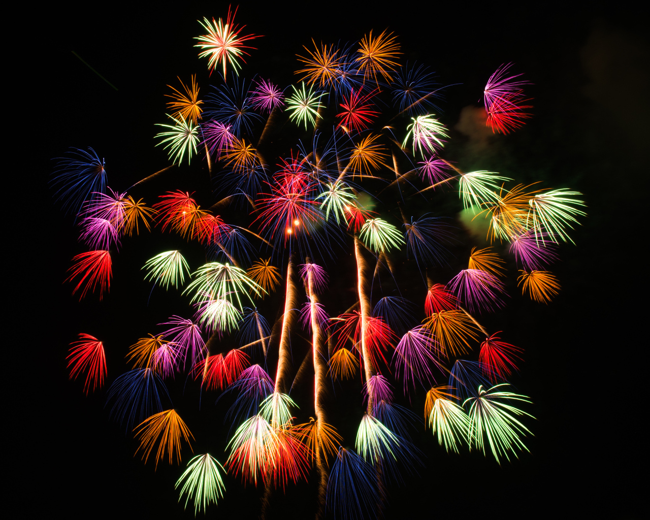 Разноцветные искры фейерверка на черном фоне