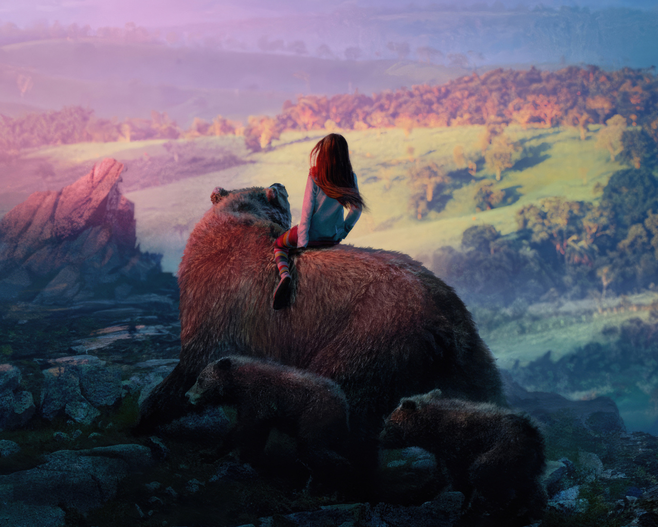 Девочка катается на большом медведе