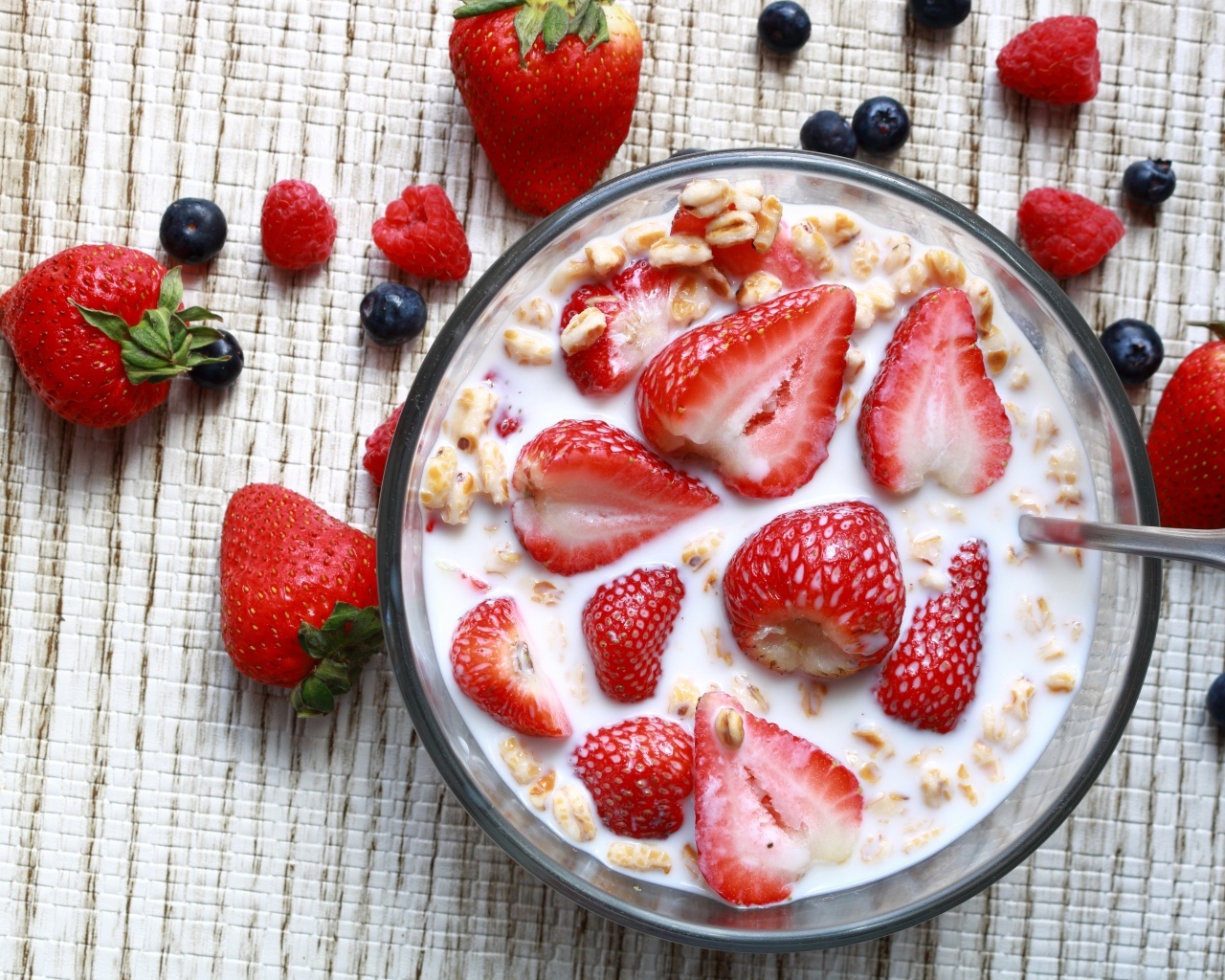 Овсянка с молоком в тарелке с ягодами малины