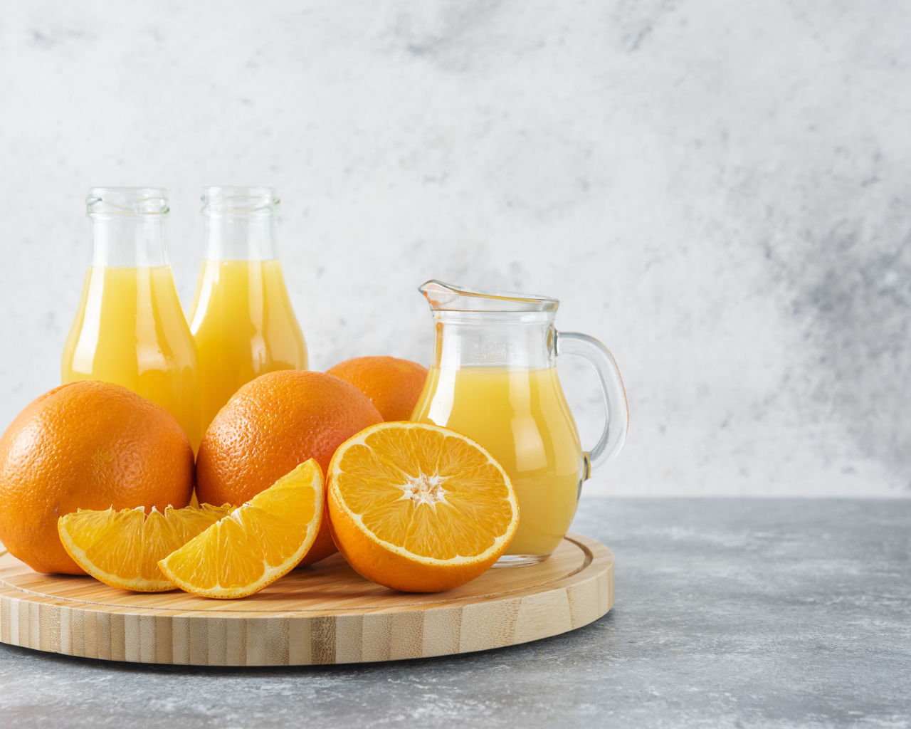 Свежевыжатый сок на столе с апельсинами