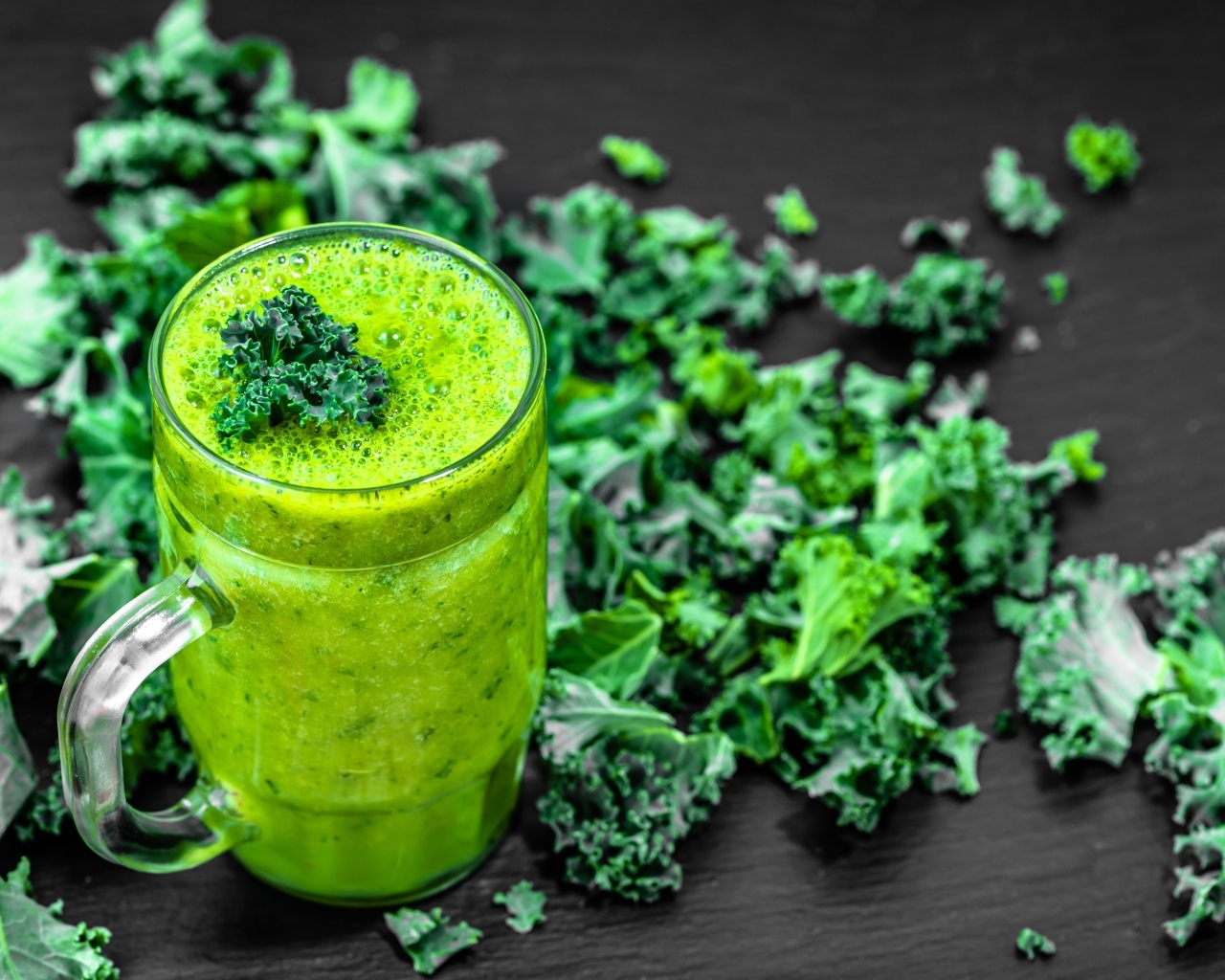 Бокал с зеленым смузи с листьями