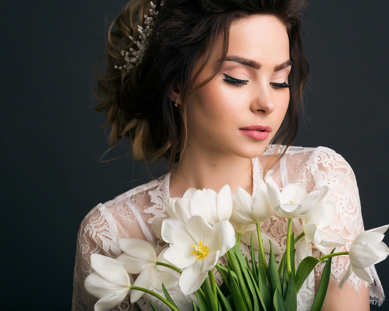 Красивая девушка с букетом белых тюльпанов на сером фоне