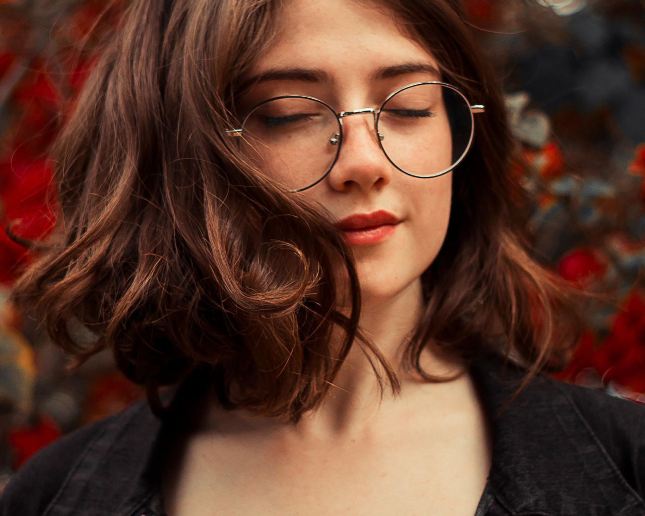 Мечтательная девушка в очках с закрытыми глазами