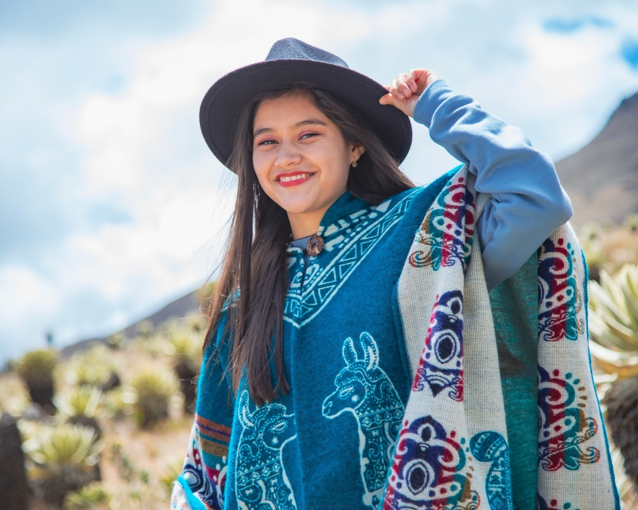 Девушка в ковбойской шляпе и пончо