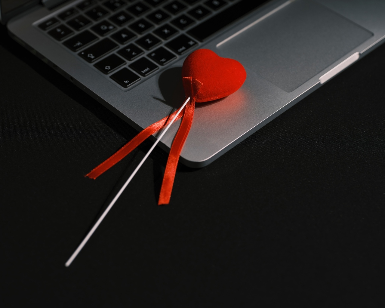 Красное сердце на палочке с ноутбуком