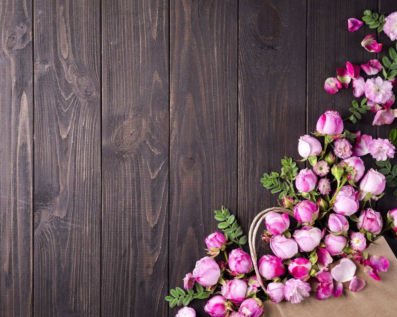 Бутоны розовой розы на деревянном столе