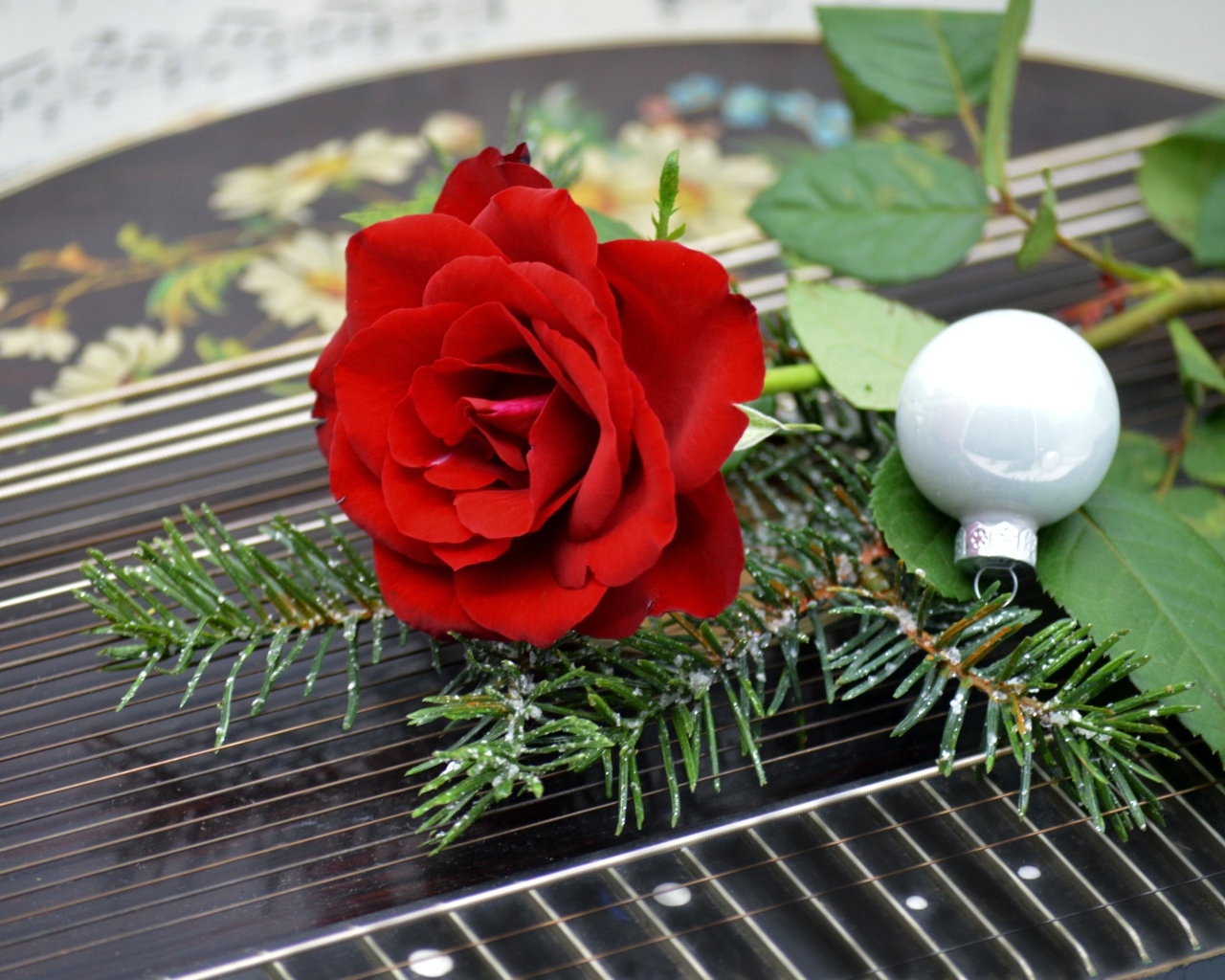 Красная роза с шариком и еловой веткой
