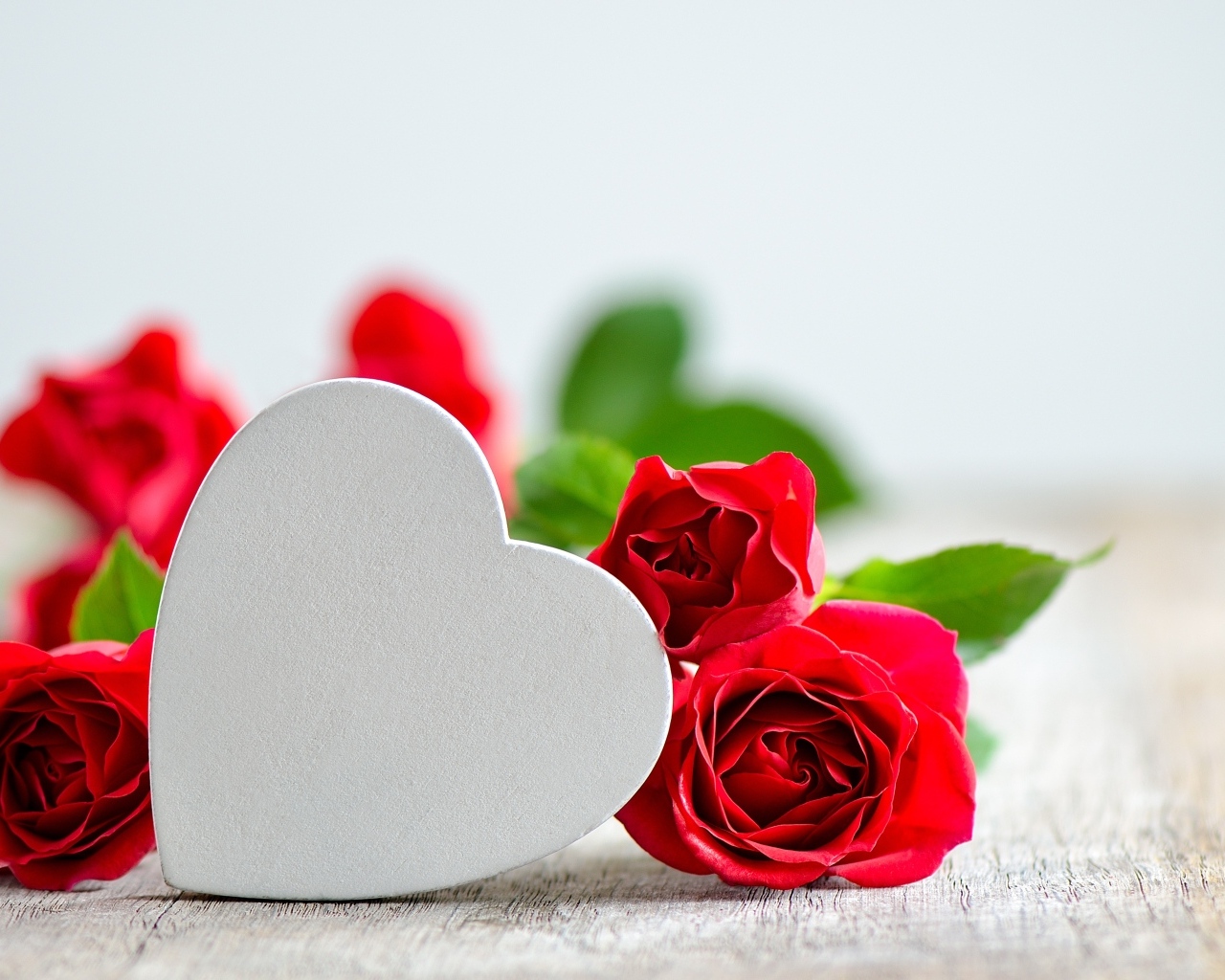 Красные розы с белым сердцем на столе