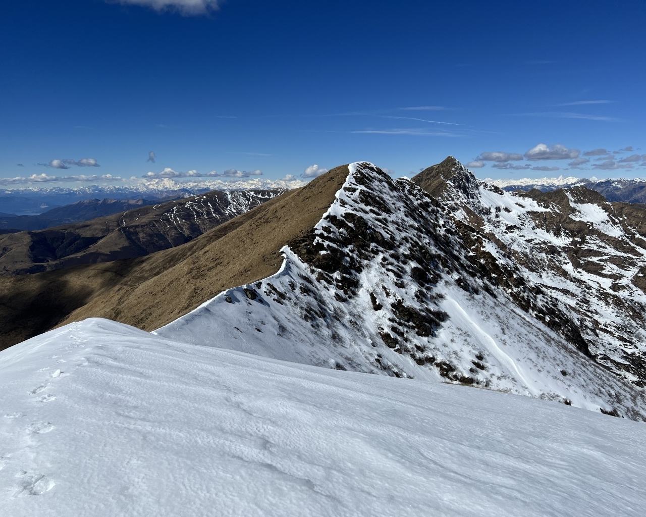 Вид на заснеженную гору под голубым небом