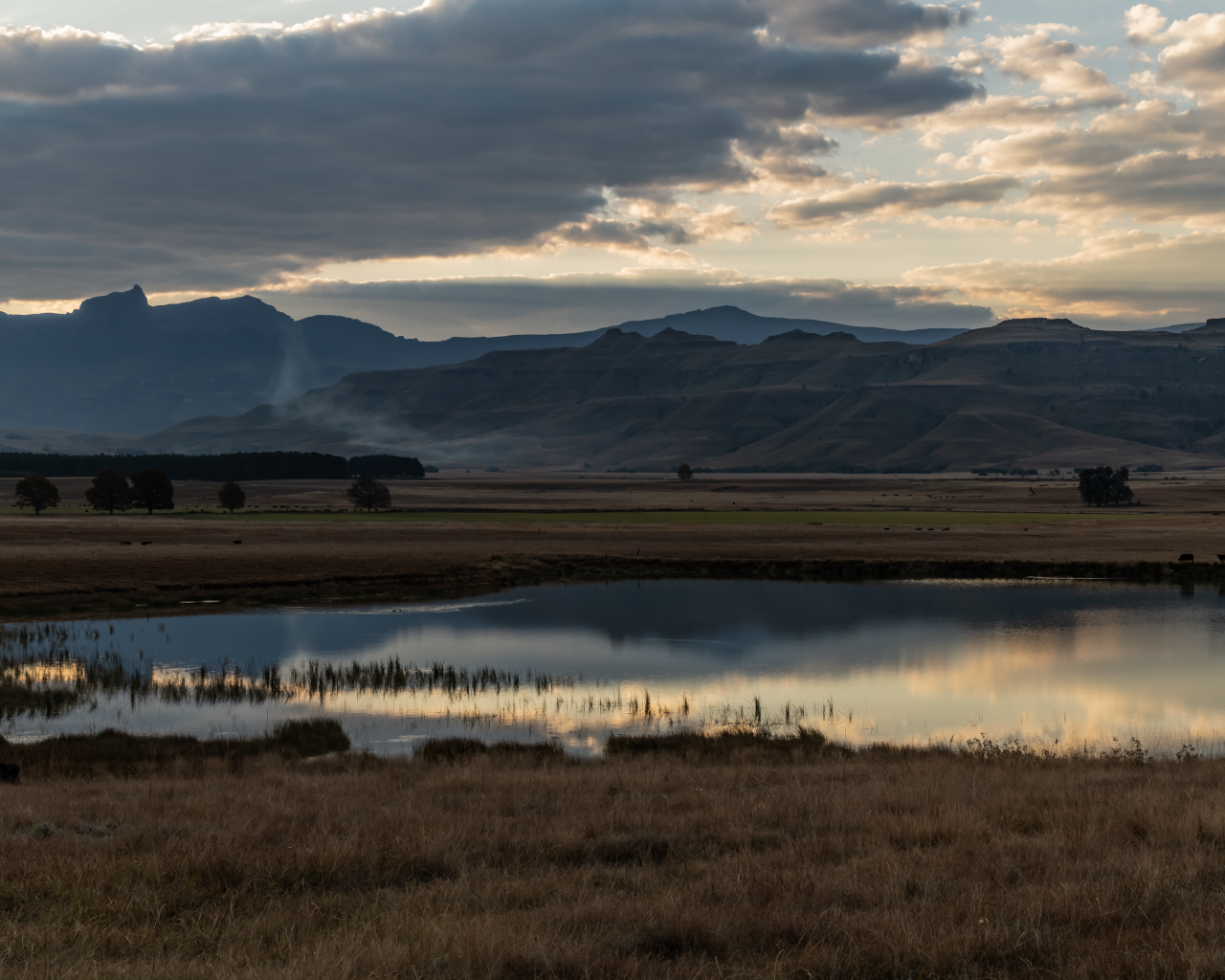 Грозовые облака отражаются в воде озера в горах 