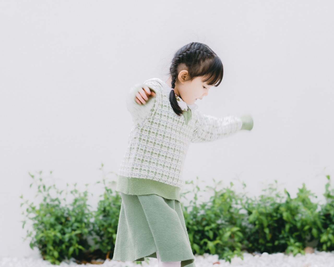 Маленькая девочка азиатка играет в саду