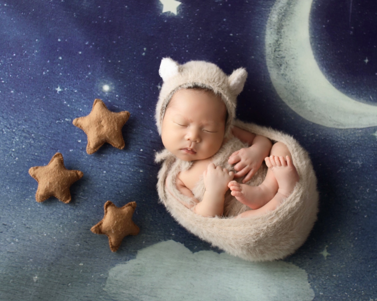 Маленький спящий грудной ребенок на синем покрывале