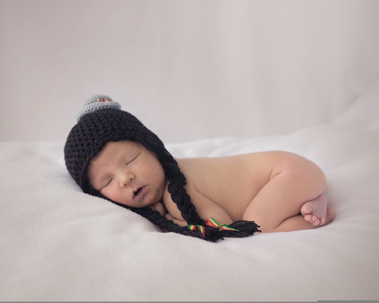 Новорожденная кроха в черной шапке