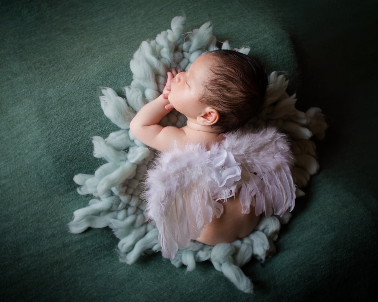 Спящий новорожденный малыш с крыльями ангела 