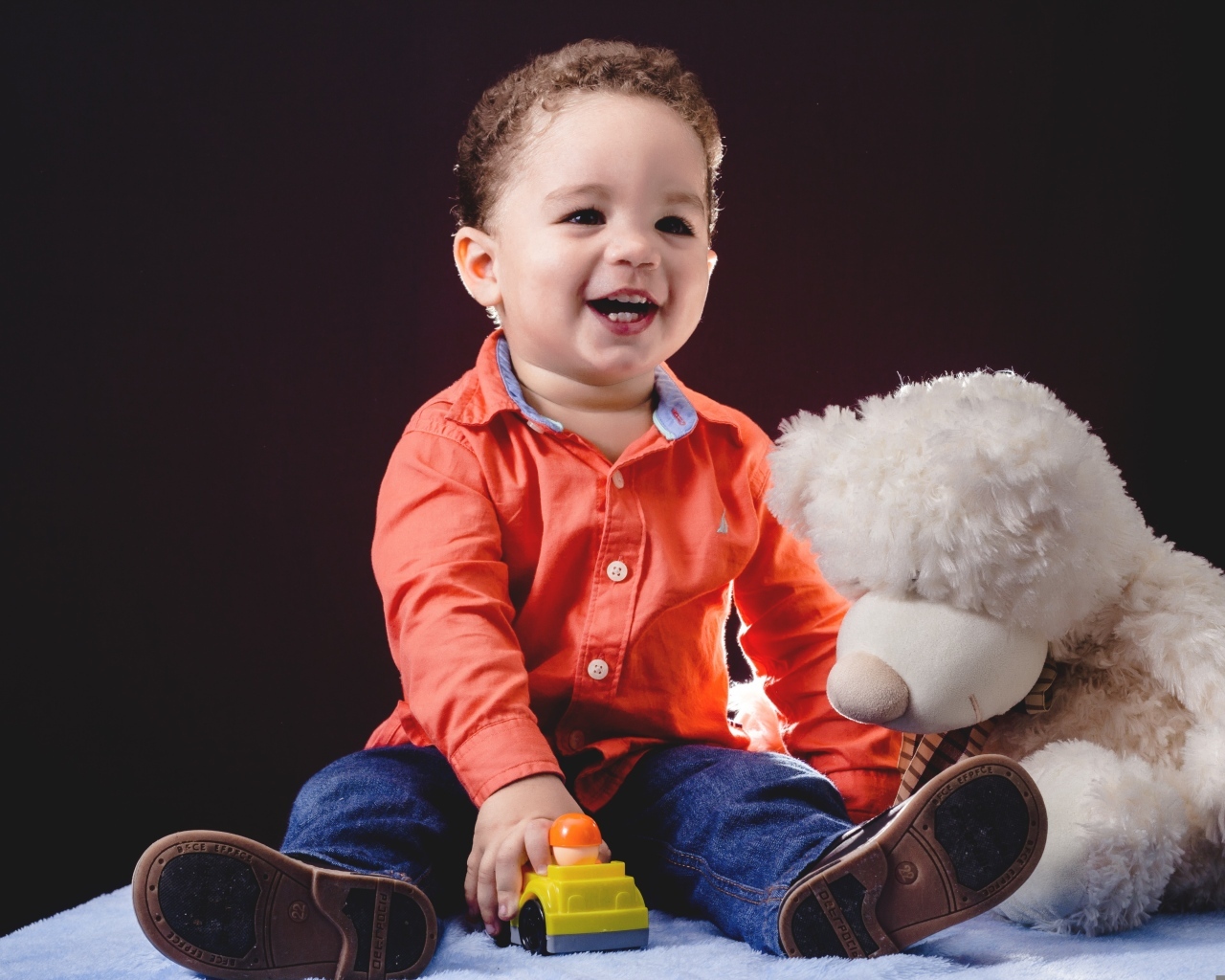 Улыбающийся мальчик с игрушечным медведем