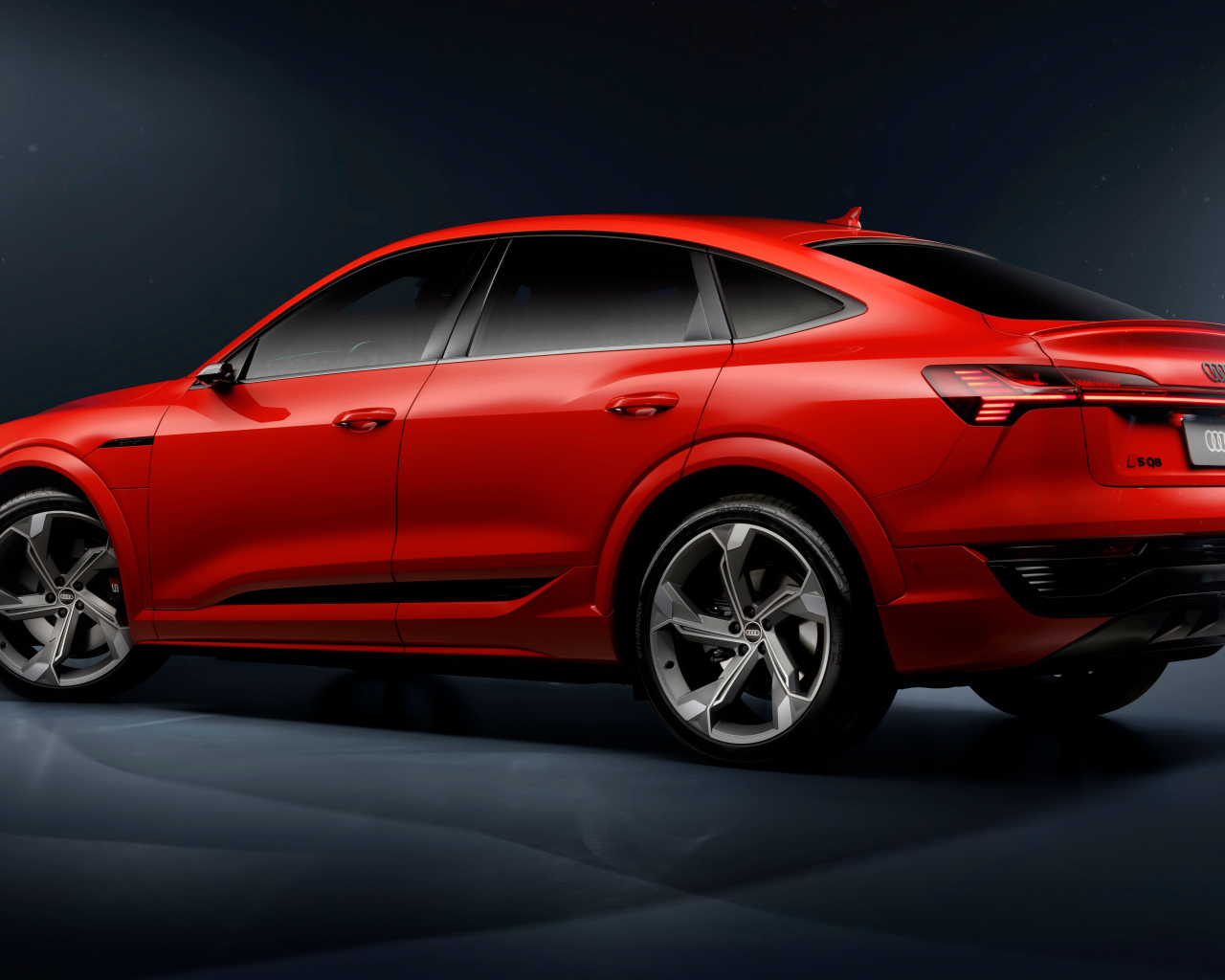 Вид сзади на красный автомобиль Audi SQ8 Sportback E-Tron Quattro 2024 года