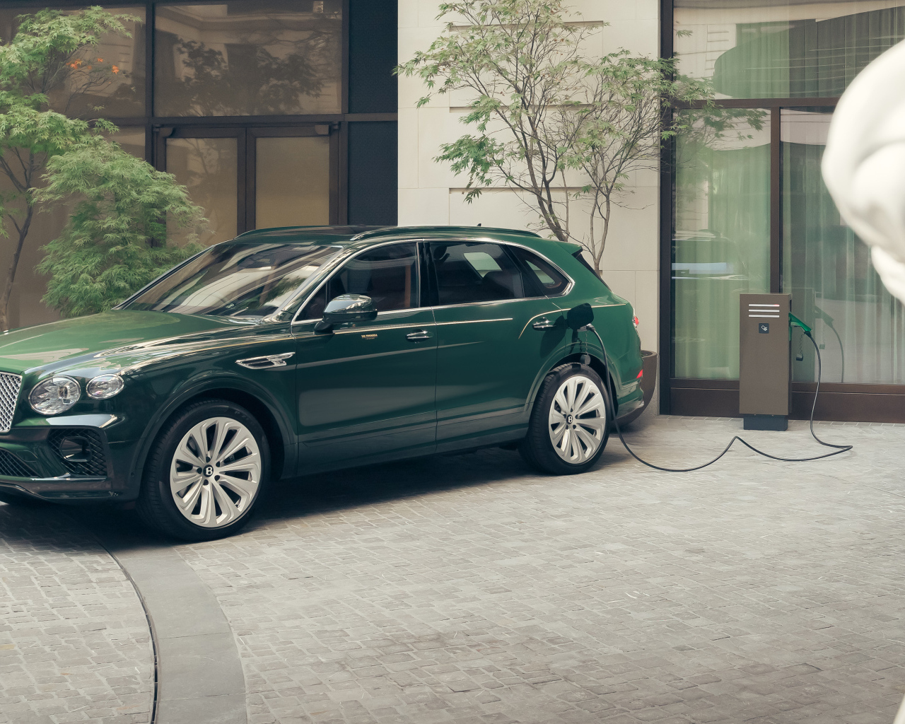 Зеленый автомобиль Bentley Bentayga Hybrid Peninsula London 2024 года