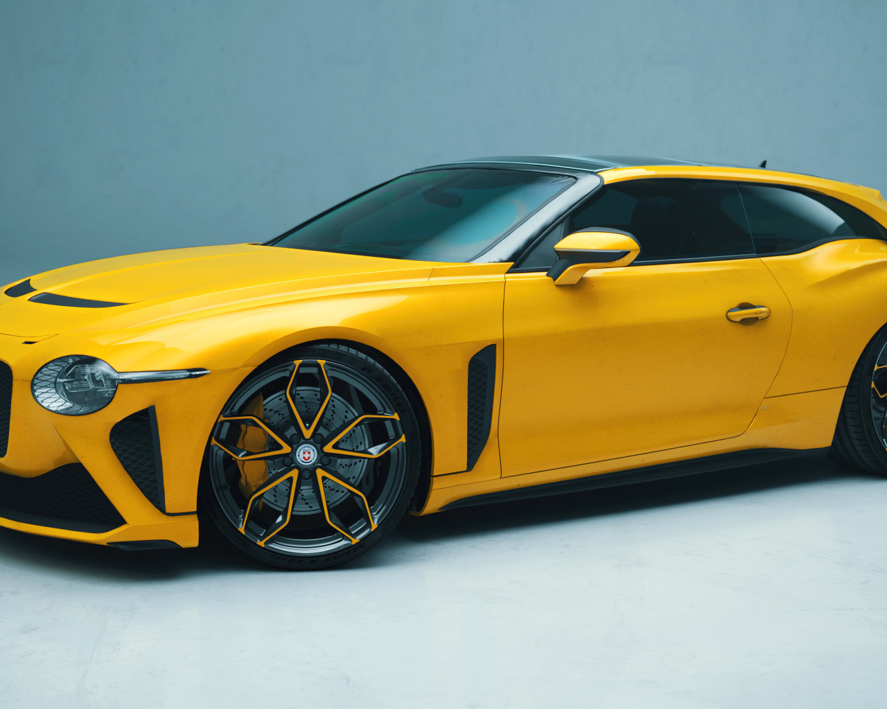 Желтый автомобиль Bentley Mulliner Bacalar на голубом фоне